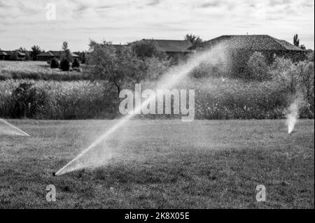 winterizing a irrigation sprinkler system by blowing pressurized air through to clear out water Stock Photo