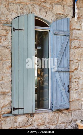 Texture Wooden blinds with metal handle and stone wall Stock Photo