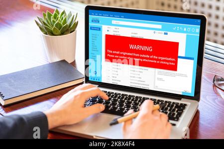 Email attachments warning message on a laptop screen. Computer Virus and Antivirus. Cyber security concept. Stock Photo