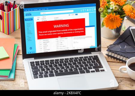 Email attachments warning message on a laptop screen. Computer Virus and Antivirus. Cyber security concept. Stock Photo