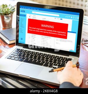 Email attachments warning message on a laptop screen. Computer Virus and Antivirus. Cyber security concept. Stock Photo