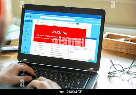 Email attachments warning message on a laptop screen. Computer Virus and Antivirus. Cyber security concept. Stock Photo