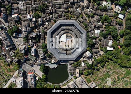 (221025) -- CHAOZHOU, Oct. 25, 2022 (Xinhua) -- This aerial photo taken on Oct. 21, 2022 shows Daoyun Lou, an octagonal Tulou earthen building compound in Raoping County of Chaozhou, south China's Guangdong Province. Daoyun Lou, China's largest octagonal Tulou earthen building, is undergoing renovations that will give it a new look by June 2023. Daoyun Lou was built in 1587 in today's Chaozhou. In 2006, it became a major historical and cultural site protected at the national level. The walled building compound covers a floor area of 10,000 square meters in the shape of Bagua, or Eight Tri Stock Photo