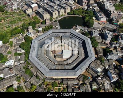 (221025) -- CHAOZHOU, Oct. 25, 2022 (Xinhua) -- This aerial photo taken on Oct. 21, 2022 shows Daoyun Lou, an octagonal Tulou earthen building compound in Raoping County of Chaozhou, south China's Guangdong Province. Daoyun Lou, China's largest octagonal Tulou earthen building, is undergoing renovations that will give it a new look by June 2023. Daoyun Lou was built in 1587 in today's Chaozhou. In 2006, it became a major historical and cultural site protected at the national level. The walled building compound covers a floor area of 10,000 square meters in the shape of Bagua, or Eight Tri Stock Photo