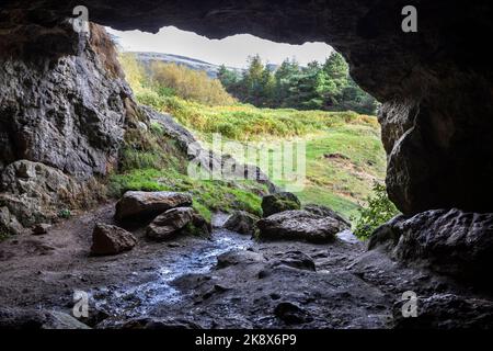 A view from a small cave near to the Odin Mine crushing wheel, Castleton in the Peak District, Derbyshire. Stock Photo