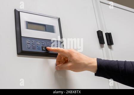 Close-up of Professional Engineer Adjusting Air Conditioner In Datacenter Stock Photo