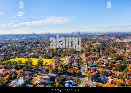 City of Ryde local residential suburbs on Sydney West in aerial cityscape view towards distant city CBD skyline. Stock Photo