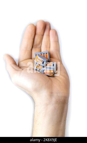 The vago terminal in the electrician's hand isolate. Selective focus. People. Stock Photo