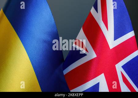 Nearby are the flags of Ukraine and Great Britain as symbols of diplomacy and support. Stock Photo