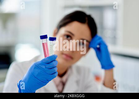 Two tubes to test. a young scientist analysing samples in test tubes in a lab. Stock Photo