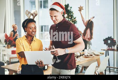 My blog seems to have grown as of this morning. a cheerful young couple smiling while using a laptop together on Christmas day at home. Stock Photo