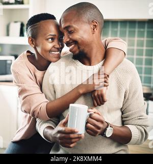 Youll always be my favorite cup of tea. a happy young couple drinking tea and spending time together at home. Stock Photo