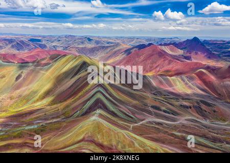 Aerial view of the entire Rainbow Mountains in Peru with Vinicunca in the center and the Red Valley in the background. Stock Photo