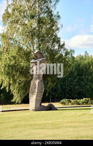 A vertical view of a victim woman monument made of stone in Salaspils memorials Stock Photo