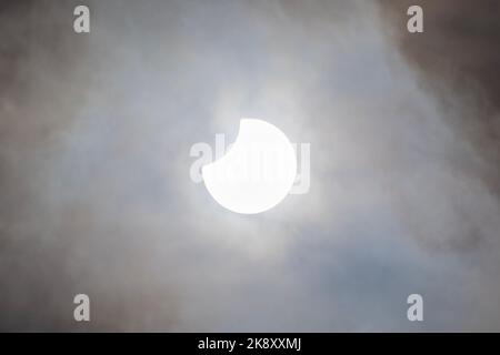 Partial Solar Eclipse with light cloud cover on October 25 2022 in Herefordshire, UK Stock Photo