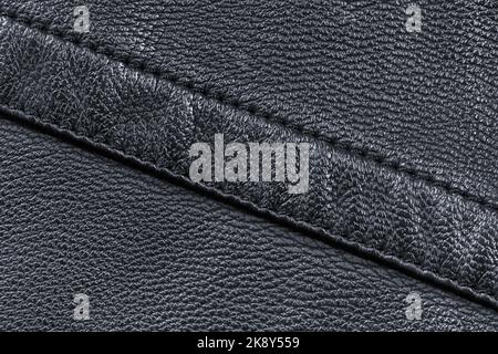 Texture of black leather stitched diagonally with double stitching Stock Photo