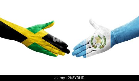 Handshake between Guatemala and Jamaica flags painted on hands, isolated transparent image. Stock Photo
