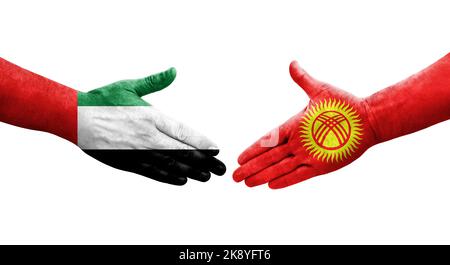 Handshake between Kyrgyzstan and UAE flags painted on hands, isolated transparent image. Stock Photo