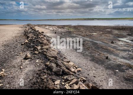 The remains of an old Cornish Hedge wall exposed by falling water levels caused by severe drought conditions at Colliford Lake Reservoir on Bodmin Moo Stock Photo