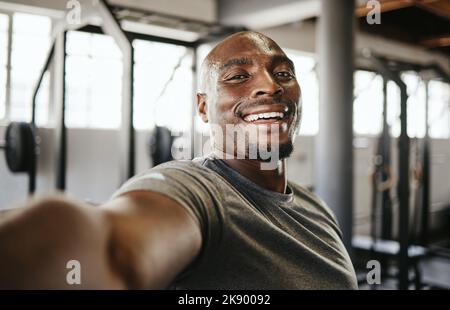 Selfie, fitness and black man training, doing a workout and cardio in the gym. Young, portrait and African athlete sweating in a photo after exercise Stock Photo