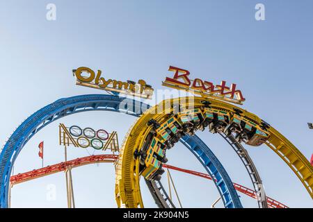 HAMBURG, GERMANY - JULY 25, 2012: people enjoy the roller coaster at Hamburg Dome. The dom is a large fair in Hamburg and attracts more than 10 millio Stock Photo