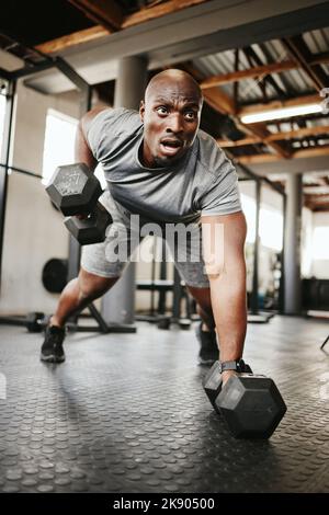 Fitness, gym and black man doing a workout with weights for strength, wellness and training. Bodybuilder, sports and strong African athlete doing push Stock Photo