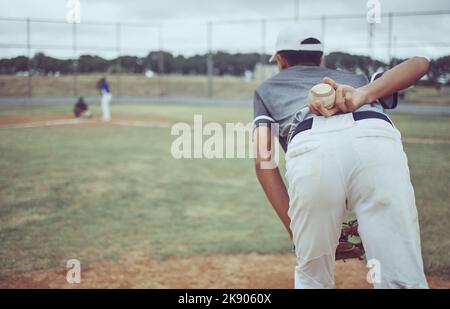 Baseball, baseball player and ball on back on baseball field ready to pitch in competition, game or match. Fitness, sports and pitcher preparing to Stock Photo