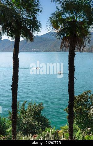 Italy lake, view in summer from the hills above the scenic town of Varenna of boats sailing on Lake Como, Lombardy, Italy Stock Photo