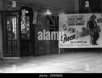 Unidentified Military Cinema A.K.C. (ARMY KINEMA CORPORATION) Garrison Cinema / Movie Theatre showing ALASTAIR SIM SALLY GRAY ROSAMUND JOHN and TREVOR HOWARD in GREEN FOR DANGER 1946 (director Sidney Gilliat) in circa early 1947 in post war Germany Stock Photo