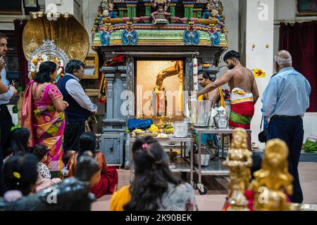 A pandit or Hindu priest performs Abhishekam puja, a Hindu ritual of ...