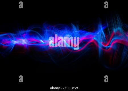 Abstract technology banner design. Long exposure, light painting. Vibrant streaks of digital neon lines on black background. Stock Photo