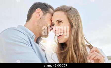 Love, happy and vacation with a couple on a date, bonding during summer while laughing or joking together. Sky, travel and smile with a man and woman Stock Photo