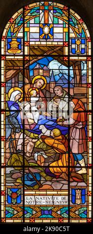 ANNECY, FRANCE - JULY 11, 2022: The  Nativity - Adoration of Shepherds in the stained glass of church Notre Dame de Lellis by L. Balmet (1933). Stock Photo