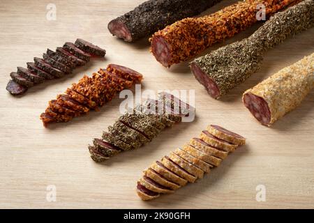 Variaton of traditional Spanish fuet and slices close up on a cuttingboard Stock Photo