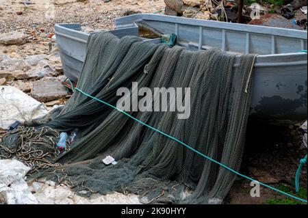 Small old fishing boat on the bank. Blue little boat. Stock Photo