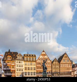 Frankfurt, Germany - February 22, 2015: statue Lady Justice with sword and scale stands in front of half timbered houses at the Roemerberg in Frankfur Stock Photo