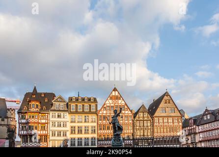 Frankfurt, Germany - February 22, 2015: statue Lady Justice with sword and scale stands in front of half timbered houses at the Roemerberg in Frankfur Stock Photo