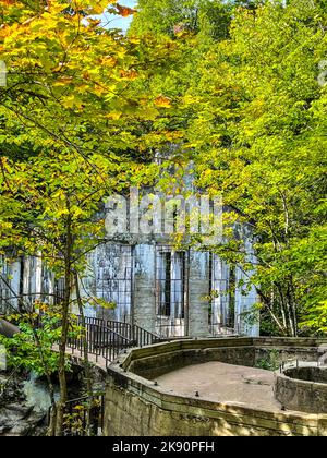 A vertical shot of Carbide Willson Ruins in a lush green forest, Gatineau Park, Chelsea, Quebec, Canada Stock Photo