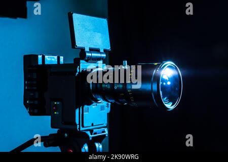 Digital cinema film camera in the dark. Video camera with copy space for film production, tv or broadcast media banner. Stock Photo