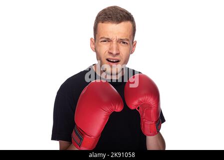 Cowardly funny young man in boxing gloves. Stock Photo