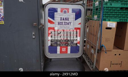 Queens Platinum Jubilee, 2022. Sign for the opening hours at a Co Op shop during this special bank holiday, with union jack. However the shop never actually shut at all.  Mundane street scene. Stock Photo