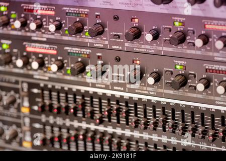 Soft focus of many different switches and levers of professional music amplifier in recording studio Stock Photo