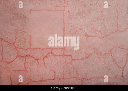 Abstract pink colored backdrop of rough textured wall with red branchy linear scratches Stock Photo