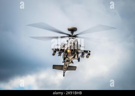 A low-angle closeup shot of a military helicopter flying on a sunny day Stock Photo