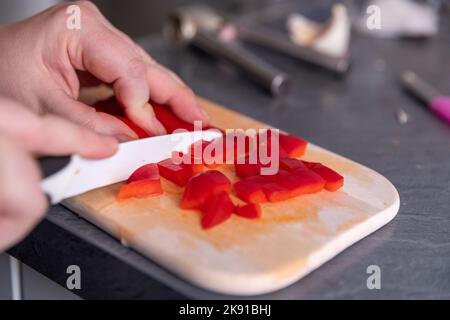 Picture of Woman's hands cutting red pepper Stock Photo