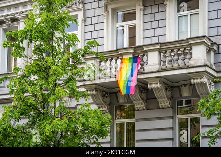 Rainbow LGBT flag hanging on the balcony of a residential building in Vilnius Stock Photo