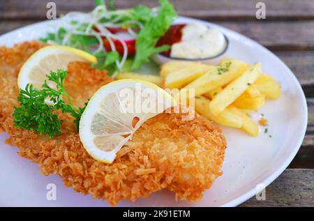Closeup of mouthwatering crispy fried fish with chips Stock Photo