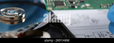 Male technician hold computer details, try to fix or collect device, dvd disc Stock Photo