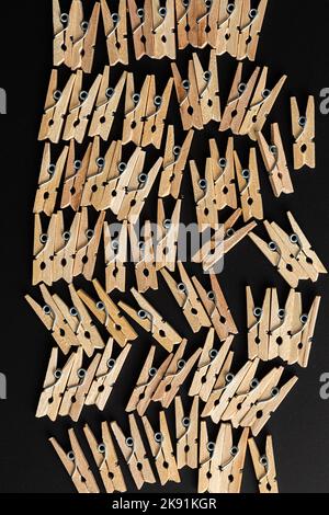 top view of a clothespins in row on dark background Stock Photo