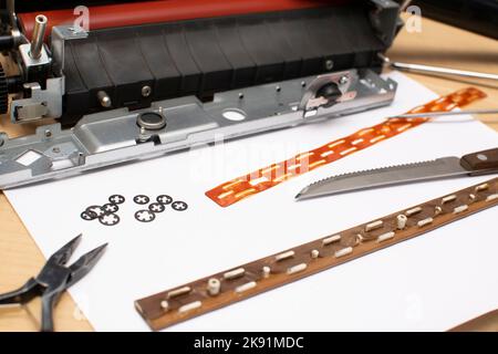tools and parts lying on a table on a white sheet of paper Stock Photo